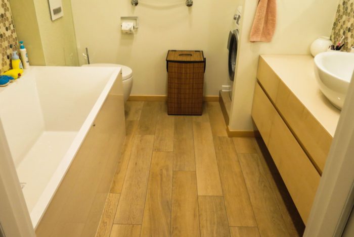 wood-look tile on the floor of a combined bathroom