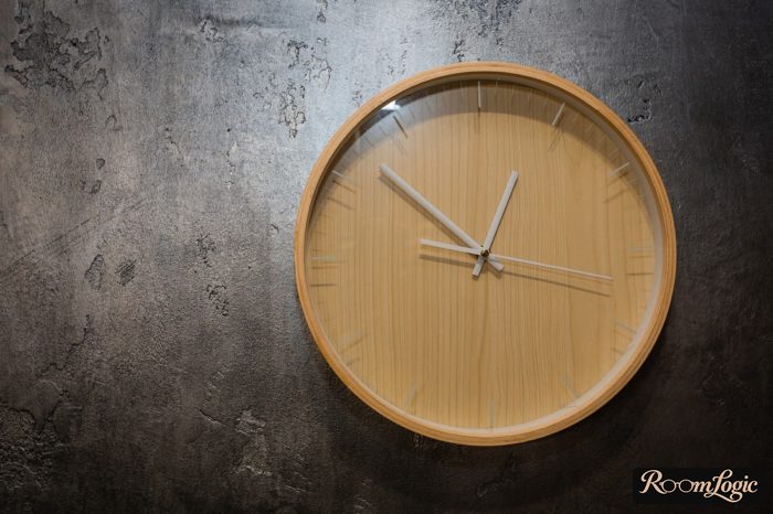 wooden clocks on black decorative plaster